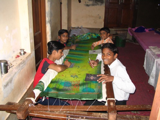 Attaching beads to a sari, the two in the back were 12, the left front 14, the right front 15.
