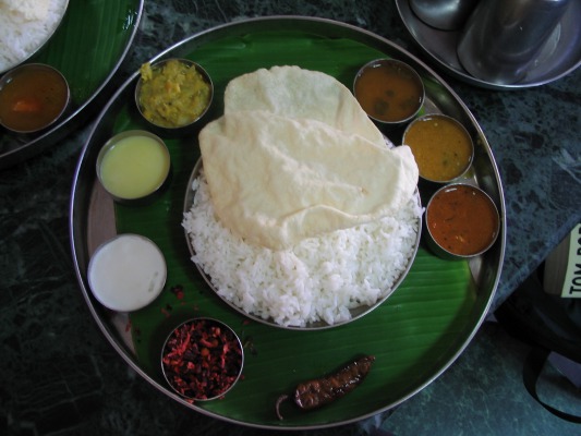 A South Indian thali (set meal). You take out all the little metal bowls, dump the rice in the middle and then mix in the contents of the bowls. You eat with your hands.