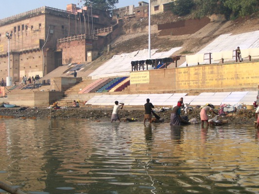 The dhobe-wallahs (washermen) washing clothes in the filthy ganga and drying them on the dirty dusty walkway.